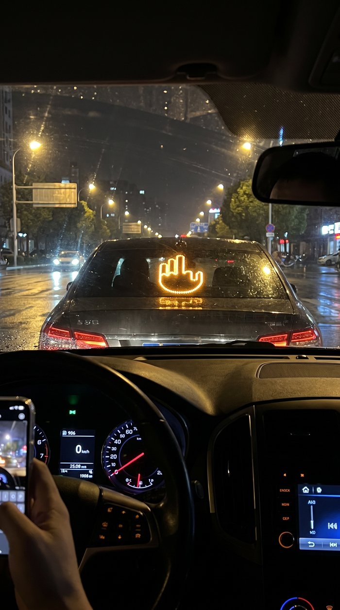 MotoRage light glowing in car rear window at night