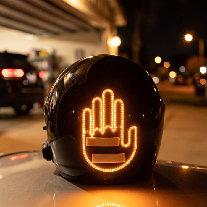 MotoRage light glowing on helmet at night